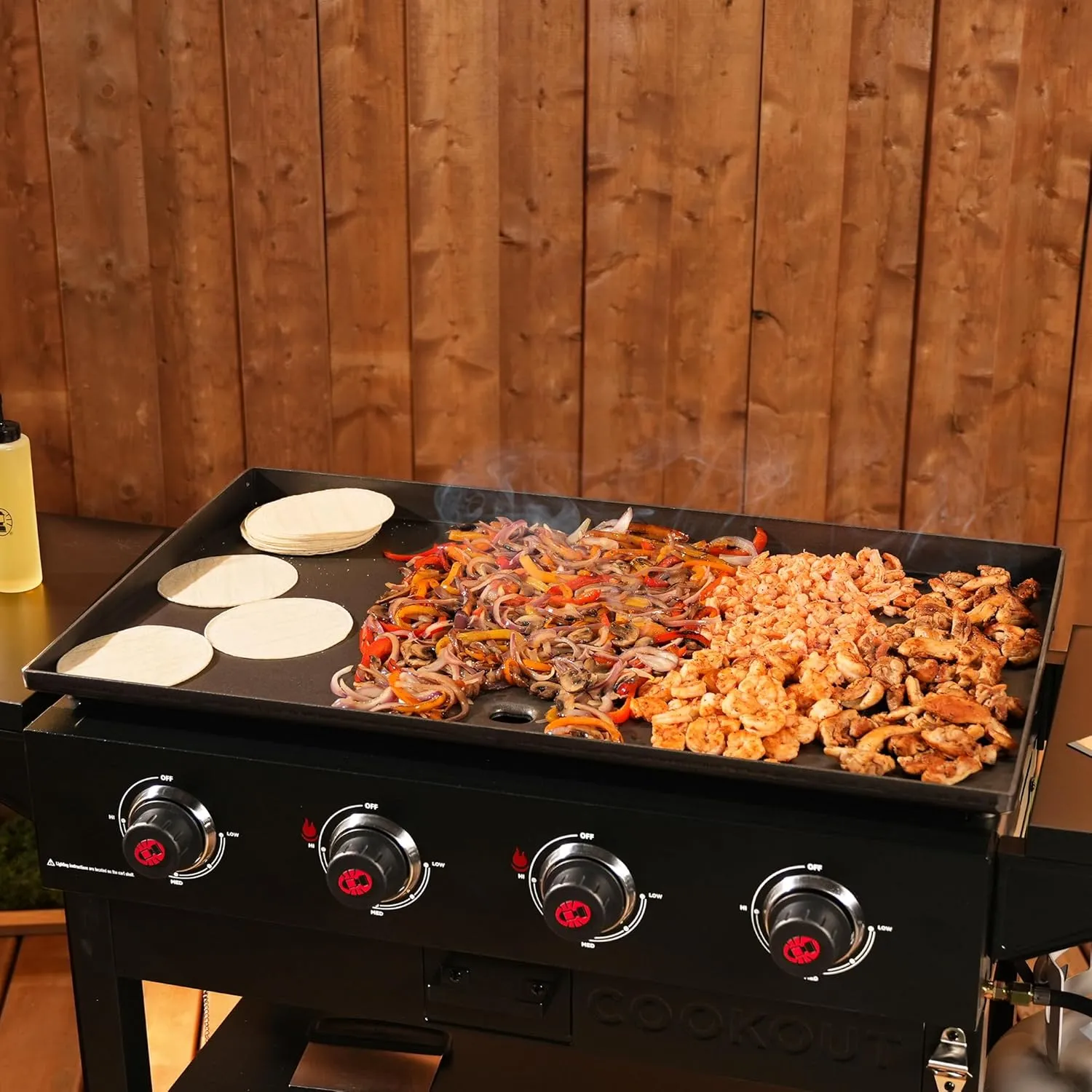 Coleman Cookout 4-Burner 60,000 BTU Propane Gas Grill Griddle Station with 720-Sq. In. Total Cooking Surface, Grease Tray, 2 Side Shelves, and 4-Wheel Cart, Propane Grill with Storage Shelves in Black